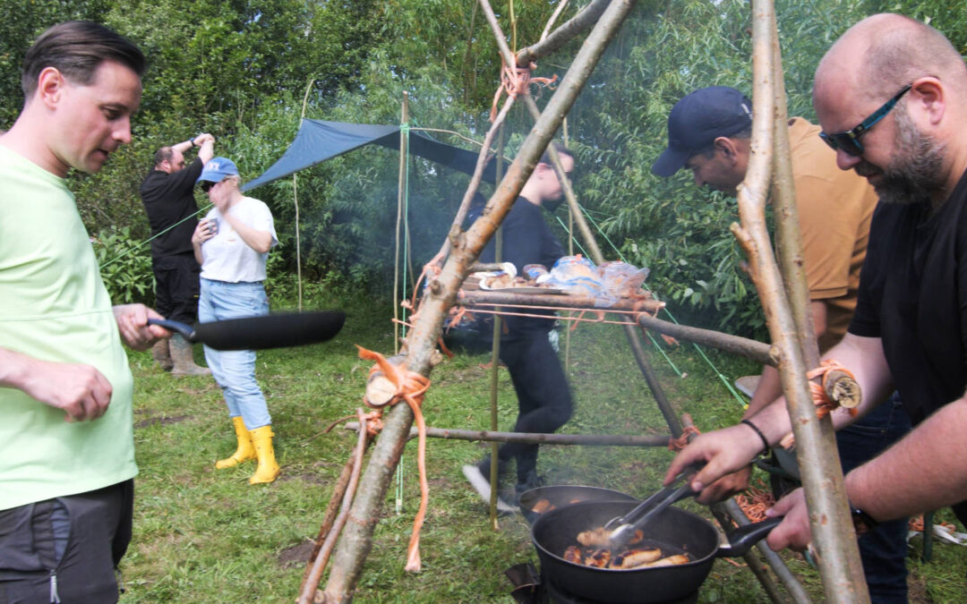 Campfire cooking image - frying sausages on a rocket stove