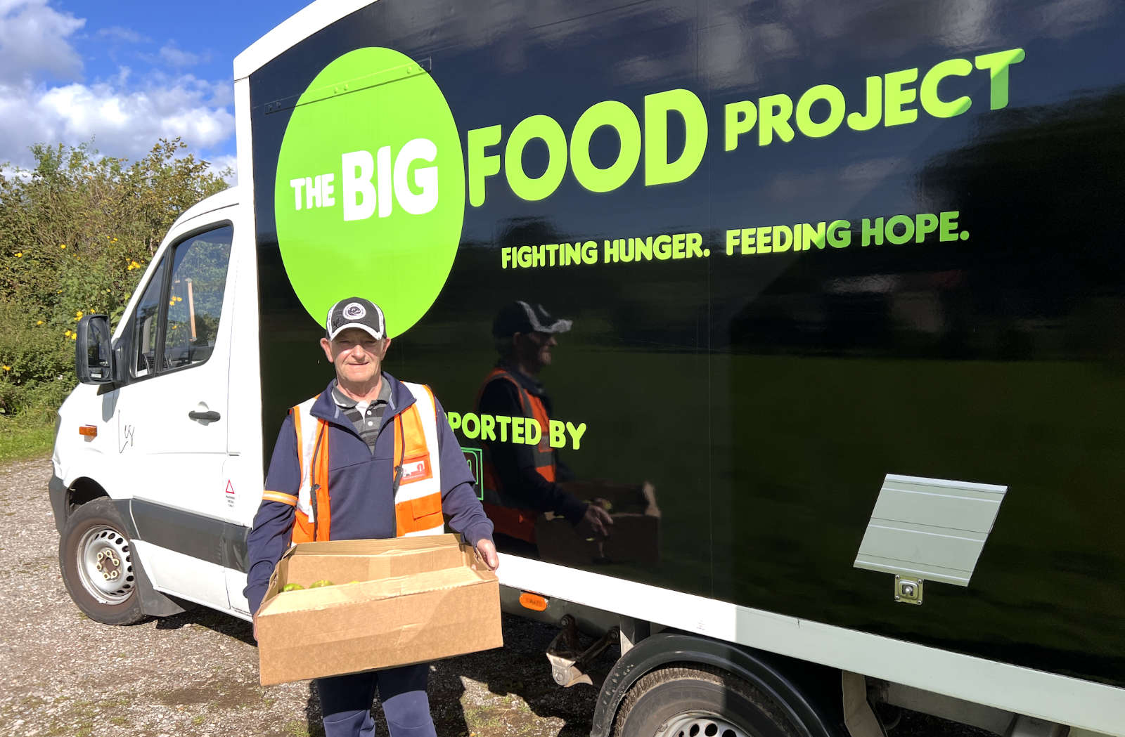 Michael of The Big Food Project loading a box of our apples onto his truck